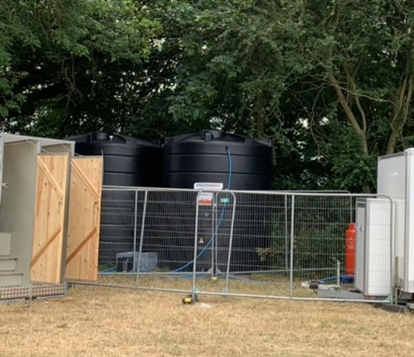 Water tanks hidden behind the toilets of the event