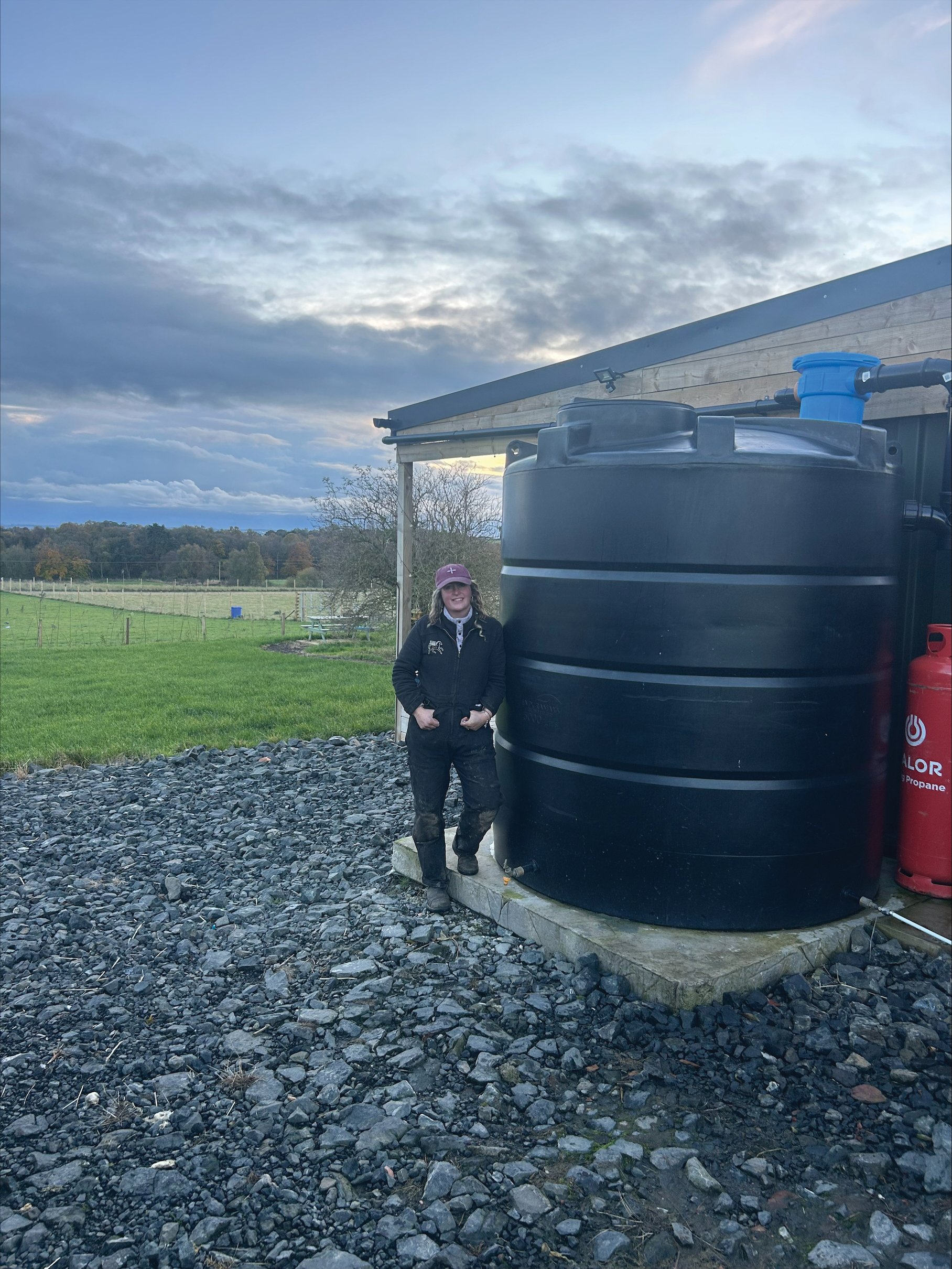 Enduramaxx's client with her rainwater harvesting kit for off-grid living