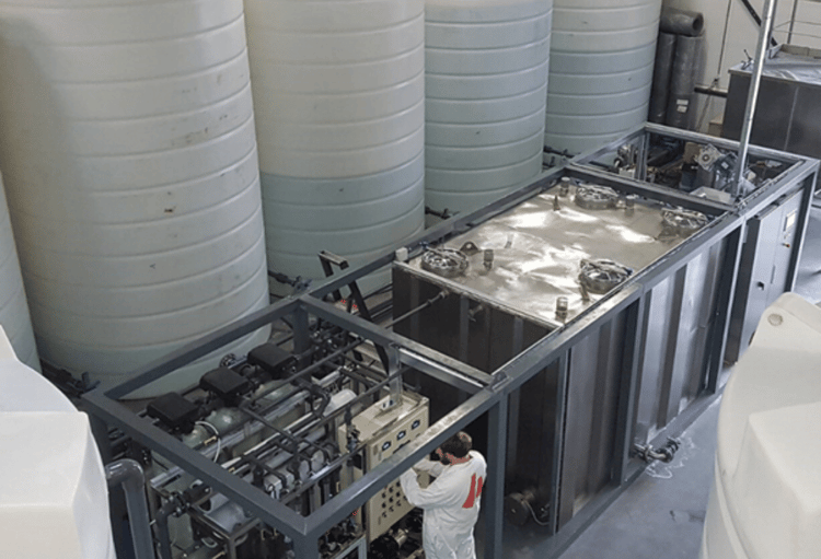 A group of industrial chemical storage containers arranged in an outdoor storage area, highlighting the importance of customised chemical storage solutions in tackling diverse project challenges.